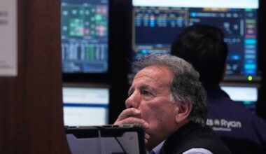 Stocks of credit card companies slump as Wall Street overall drifts in mixed trading