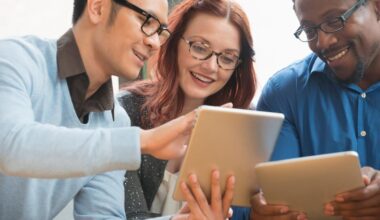 Three investors look at something on a tablet.