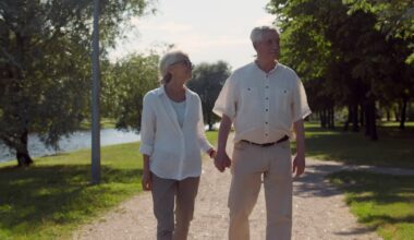 Two people holding hands outdoors.