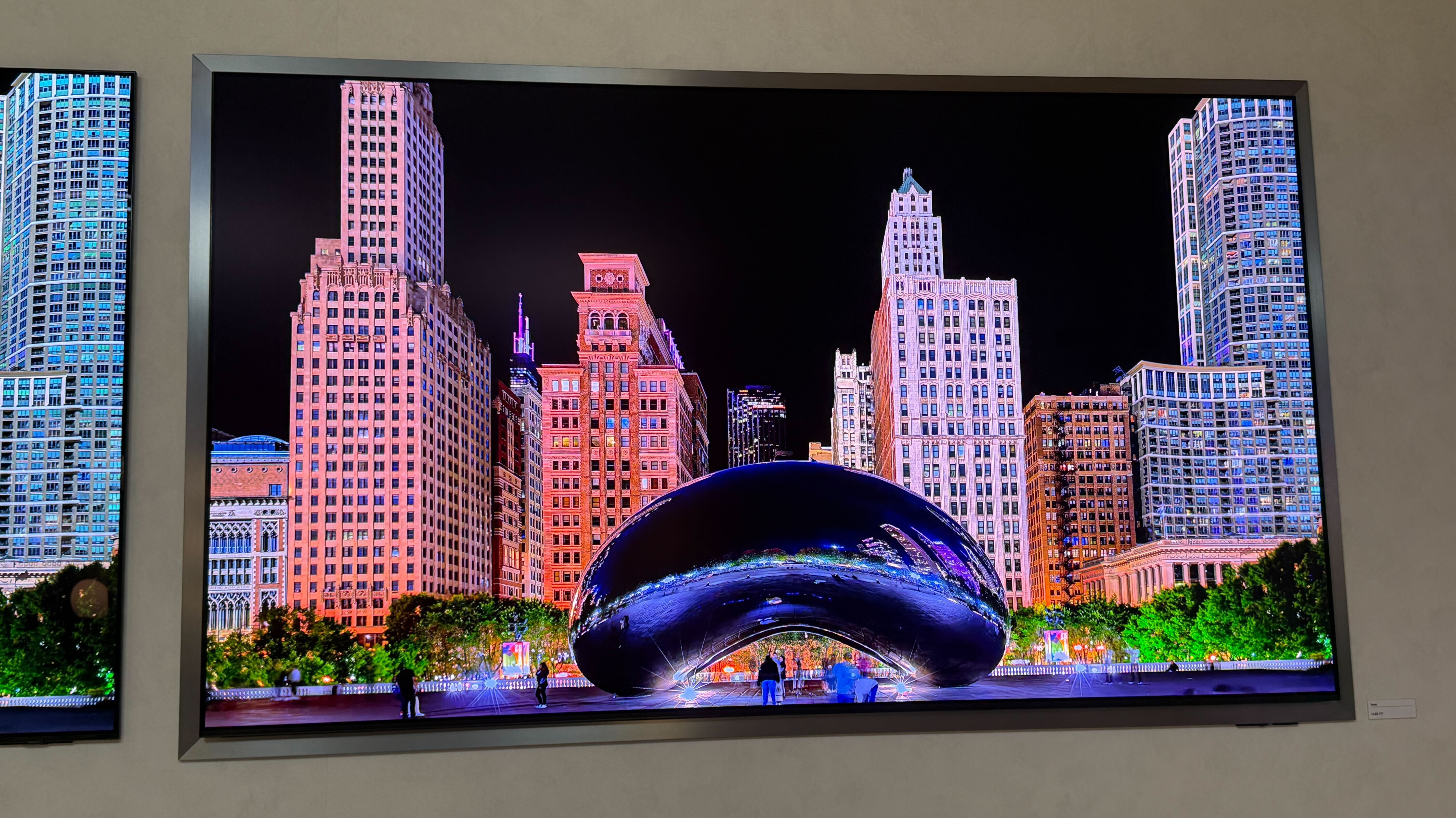 A wall mounted Samsung S95H showing stock footage of Las Vegas at night time