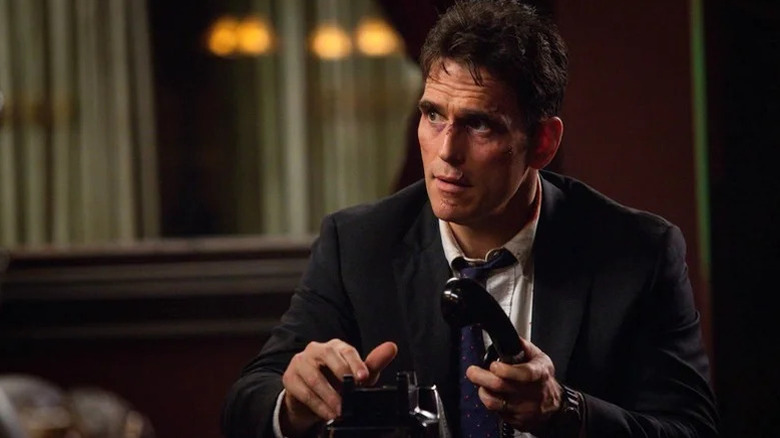 A disheveled Ethan Burke (Matt Dillon) holds a telephone in Wayward Pines