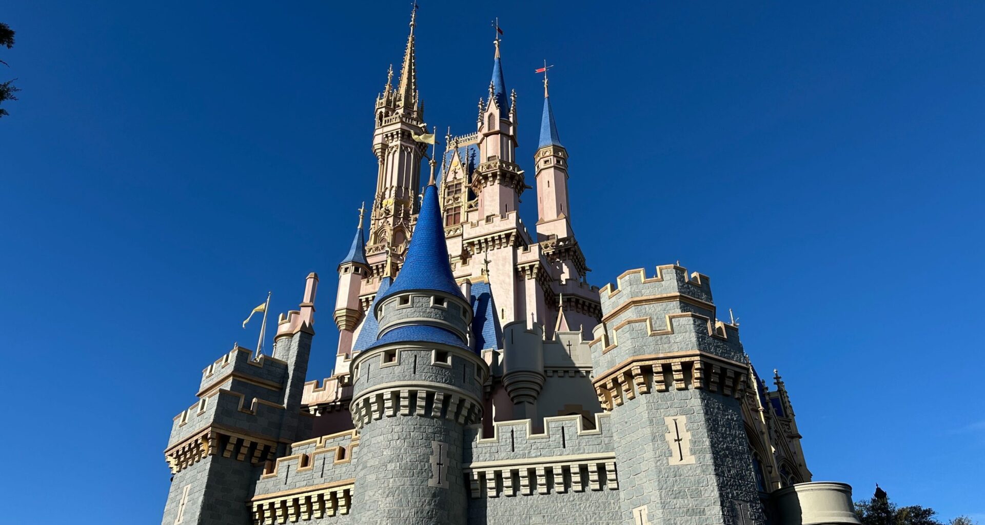 Work has begun on the Cinderella Castle repainting project at Magic Kingdom. A small portion is painted light gray.