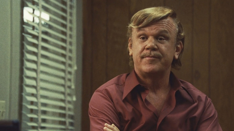 John C. Reilly as Jerry Buss folds his arms in Winning Time: The Rise of the Lakers Dynasty