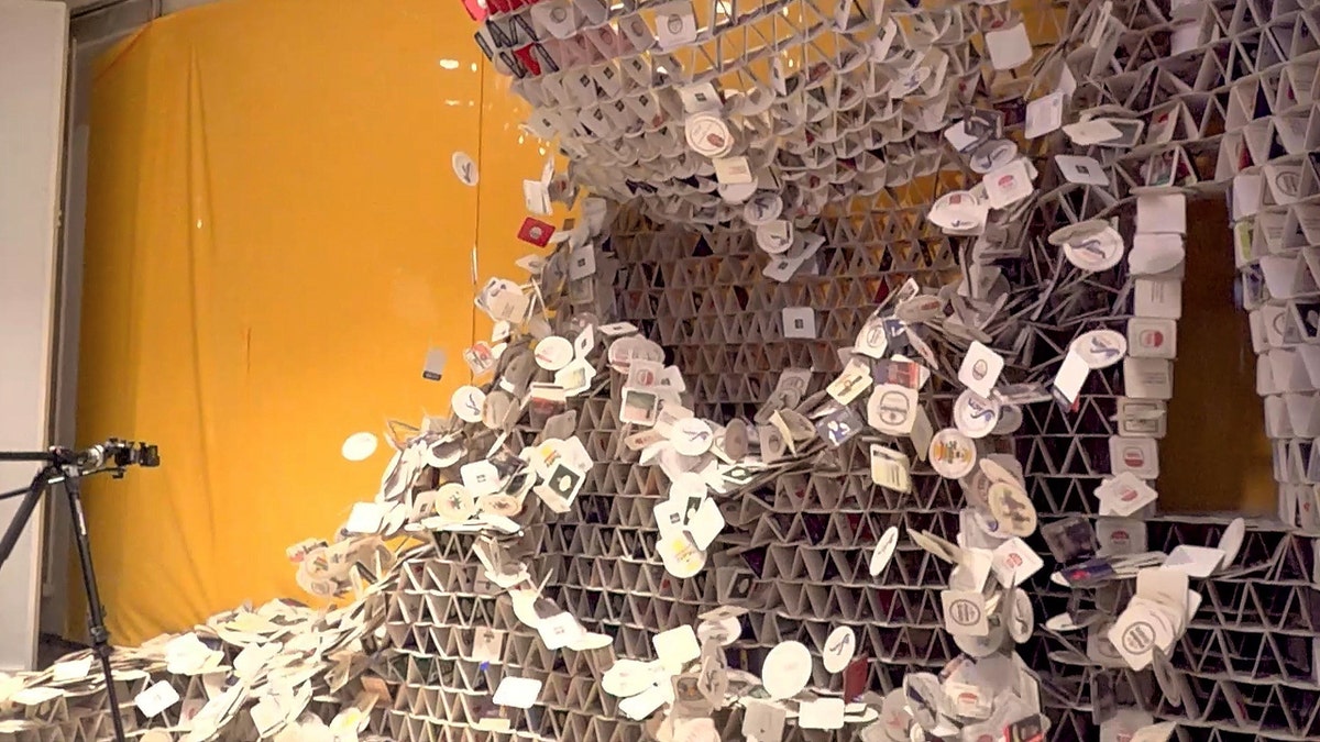 A tower of beer coasters falling down