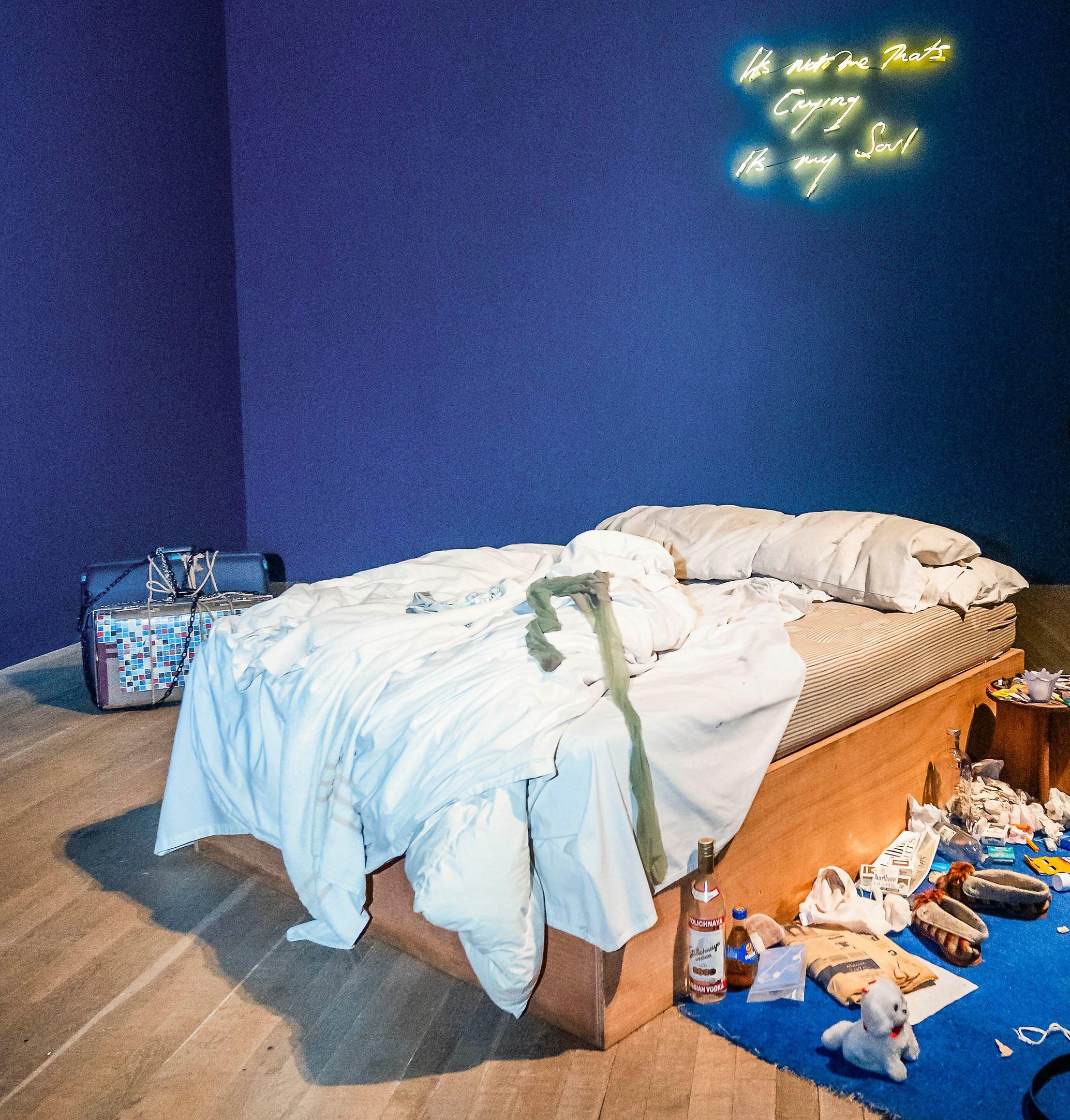 Artist Tracey Emin standing next to her installation "My Bed" at Tate Modern.