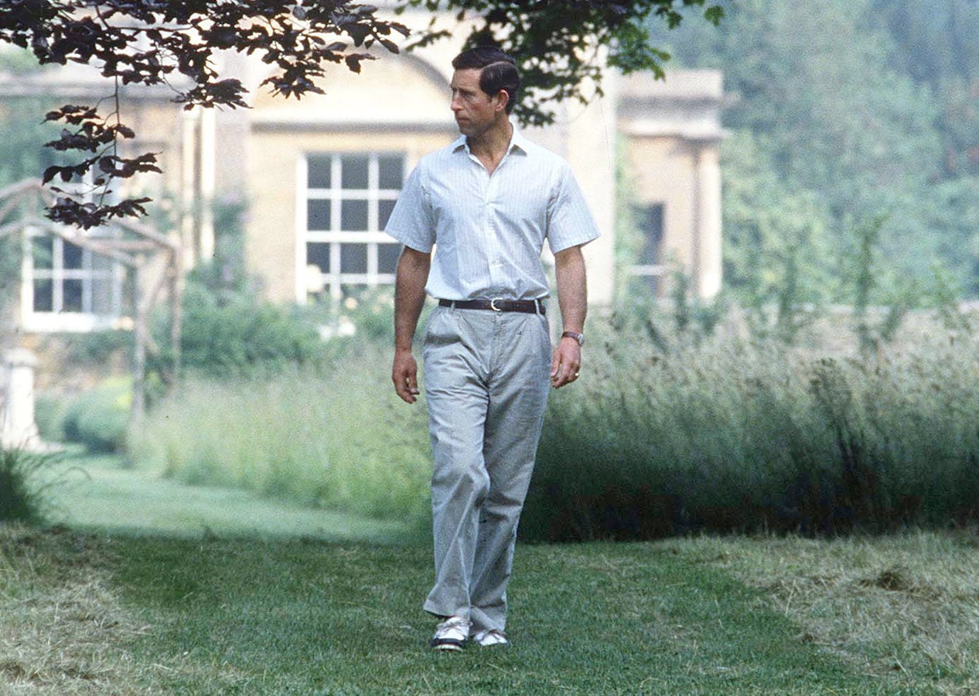 Prince Charles walking in the gardens of Highgrove House.