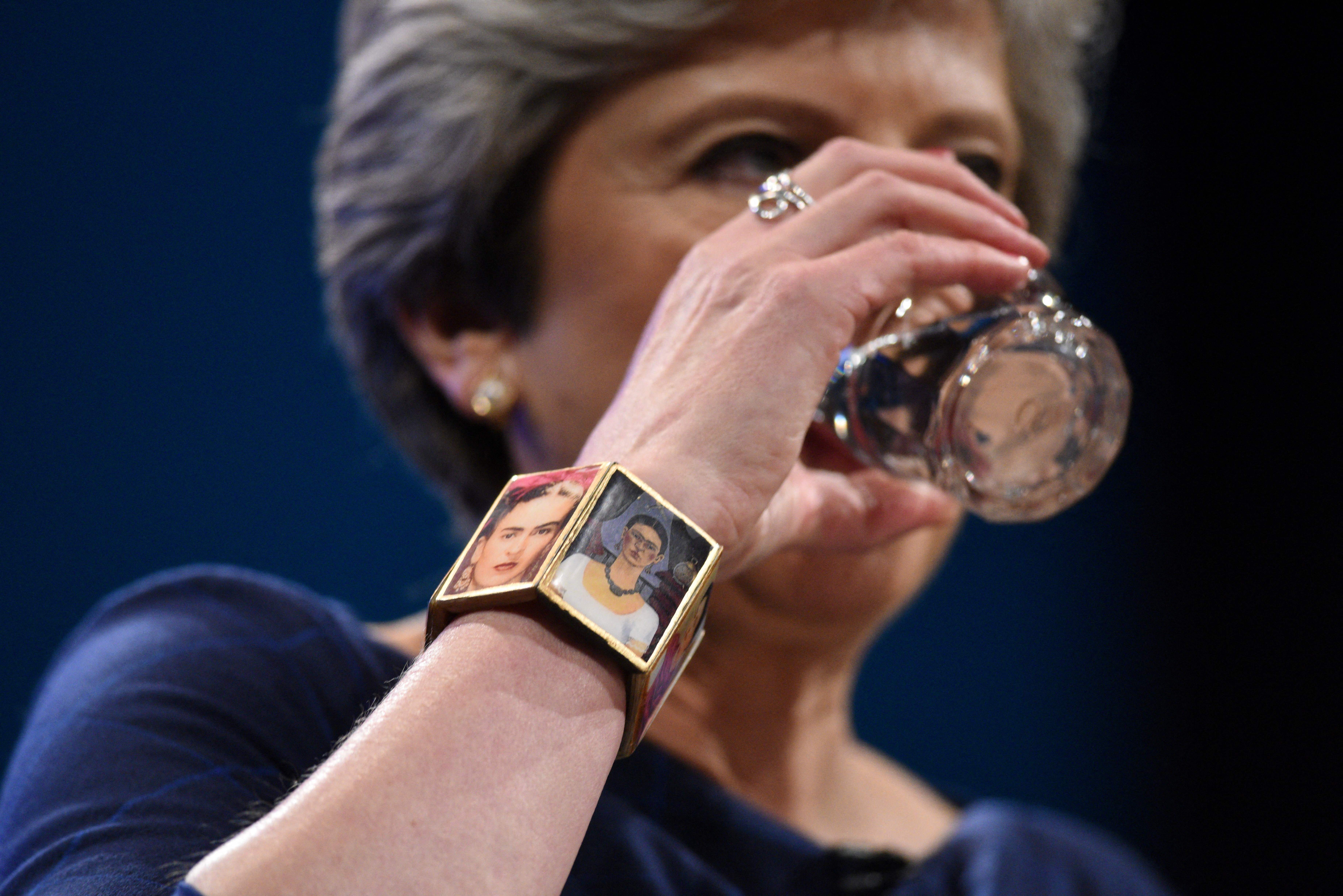 A close-up of Theresa May wearing a bracelet with two images of Frida Kahlo.