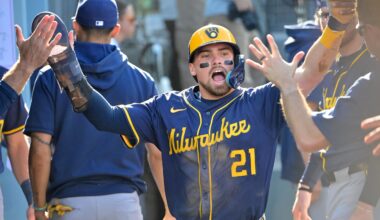 Oct 16, 2025; Los Angeles, California, USA; Milwaukee Brewers third baseman Caleb Durbin (21) celebrates in the dugout after scoring against the Los Angeles Dodgers in the second inning during game three of the NLCS round for the 2025 MLB playoffs at Dodger Stadium. Mandatory Credit: Jayne Kamin-Oncea-Imagn Images