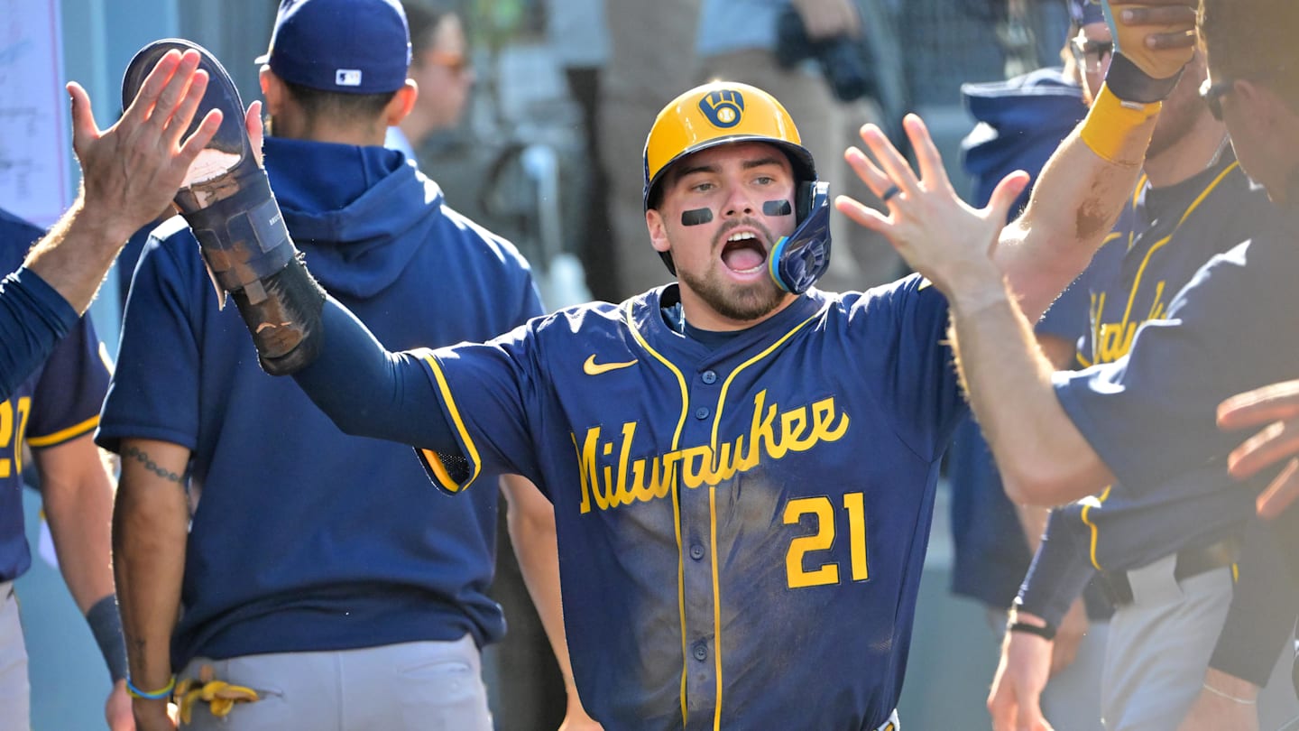 Oct 16, 2025; Los Angeles, California, USA; Milwaukee Brewers third baseman Caleb Durbin (21) celebrates in the dugout after scoring against the Los Angeles Dodgers in the second inning during game three of the NLCS round for the 2025 MLB playoffs at Dodger Stadium. Mandatory Credit: Jayne Kamin-Oncea-Imagn Images