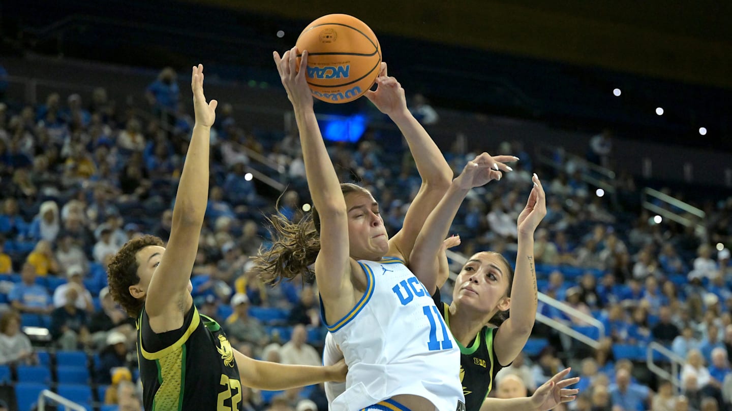 Dec 7, 2025; Los Angeles, California, USA;  UCLA Bruins guard Gabriela Jaquez (11) is defended by Oregon Ducks guard Janiyah Williams (22) and guard Katie Fiso (2) as she drives to the basket during the first half at Pauley Pavilion presented by Wescom Financial. Mandatory Credit: Jayne Kamin-Oncea-Imagn Images