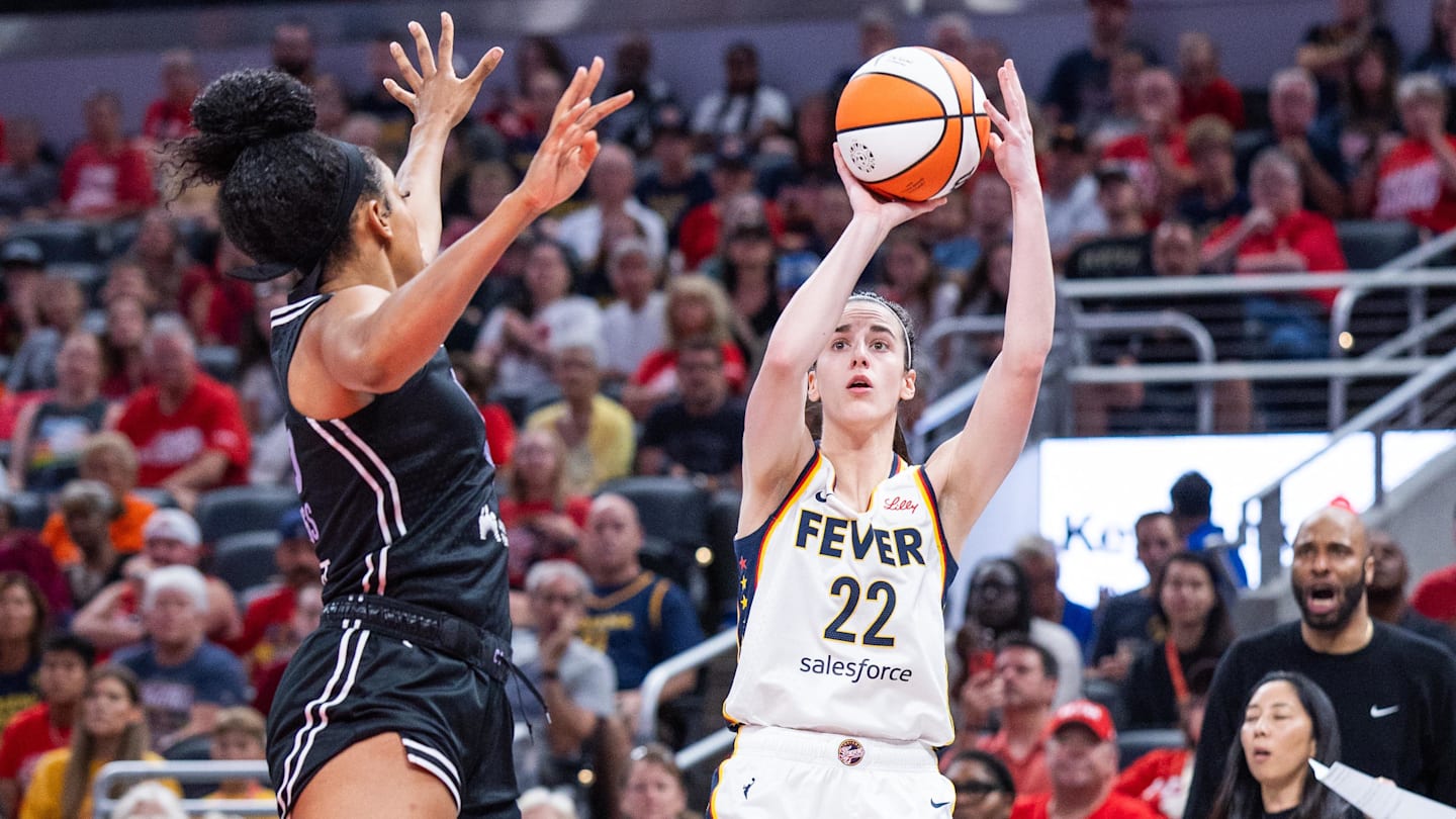 Jul 9, 2025; Indianapolis, Indiana, USA; Indiana Fever guard Caitlin Clark (22) shoots the ball while Golden State Valkyries forward Monique Billings (25) defends in the first half at Gainbridge Fieldhouse. Mandatory Credit: Trevor Ruszkowski-Imagn Images
