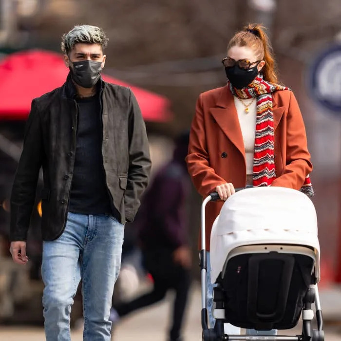 Zayn and Gigi walking outside with a stroller
