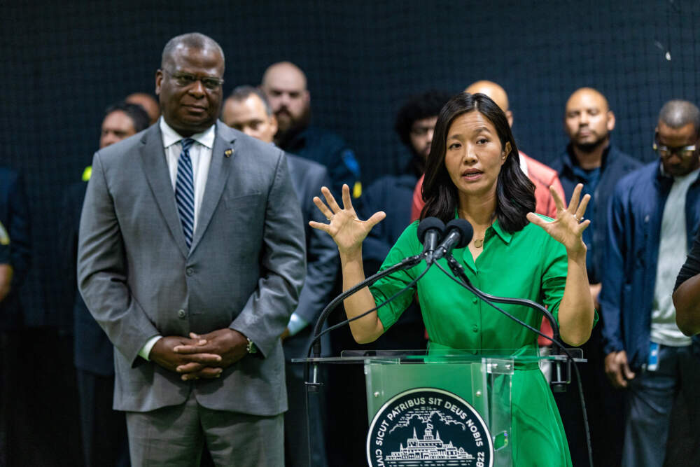 In August 2023, Mayor Michelle Wu, with Police Commissioner MIchael Cox to her right, outlined her approach to solving the crisis at Mass and Cass during a press Conference at the Base in Roxbury. (Jesse Costa/WBUR)