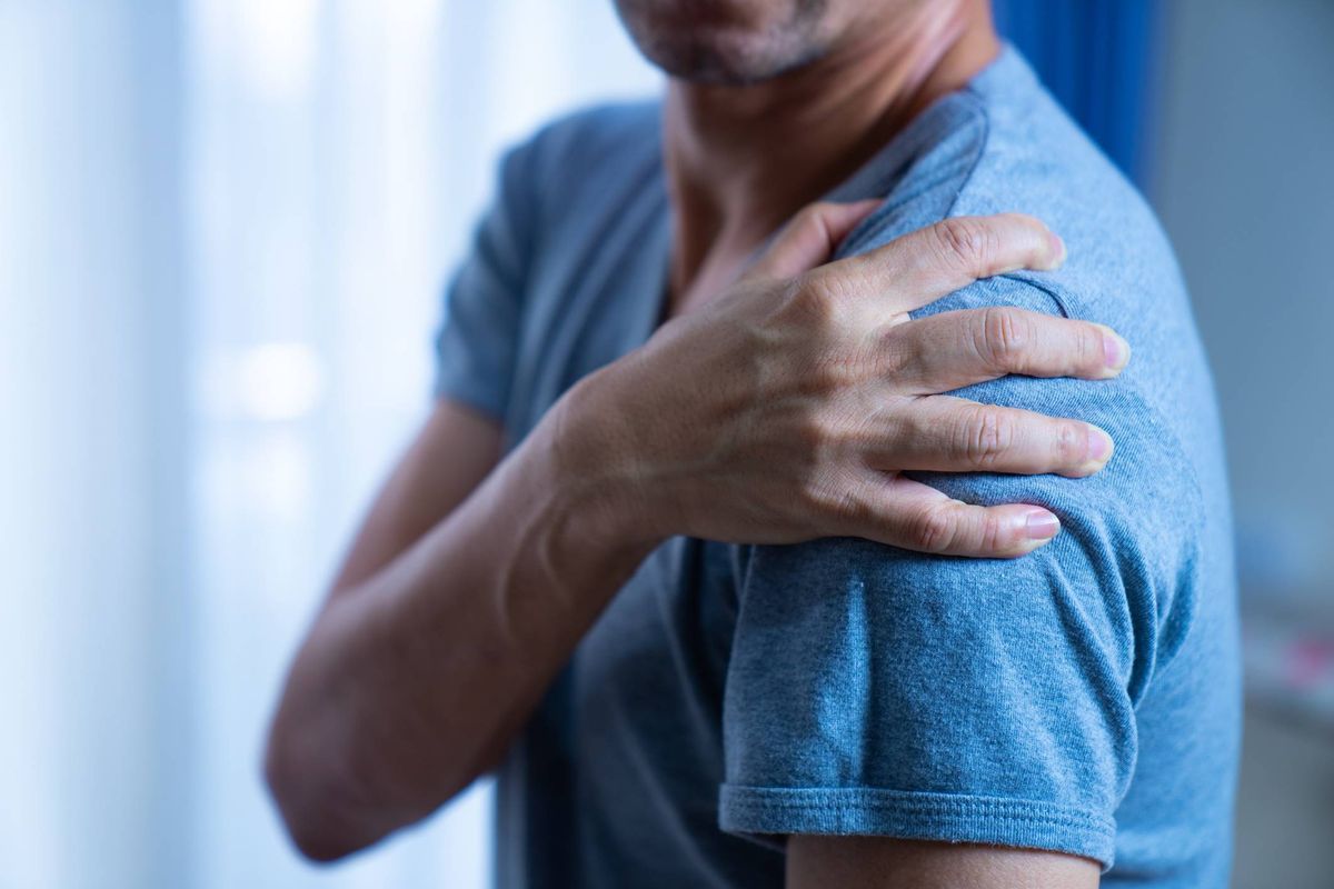 Man holding his painful shoulder