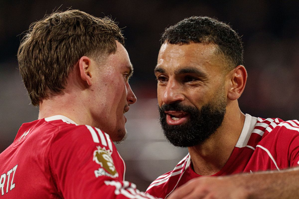 Florian Wirtz celebrates with Mohamed Salah after scoring Liverpool's third goal during the Premier League match against Newcastle United at Anfield on January 31 2026