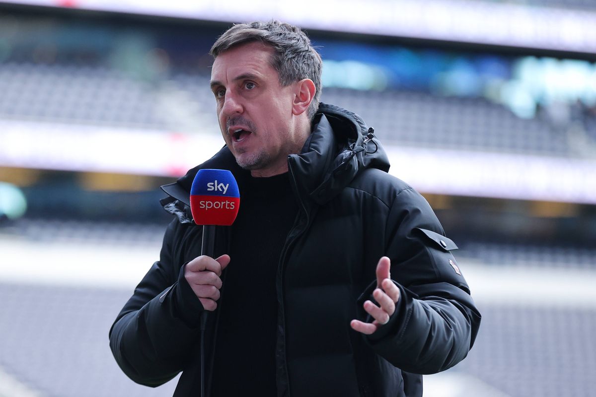 Gary Neville speaks into a microphone