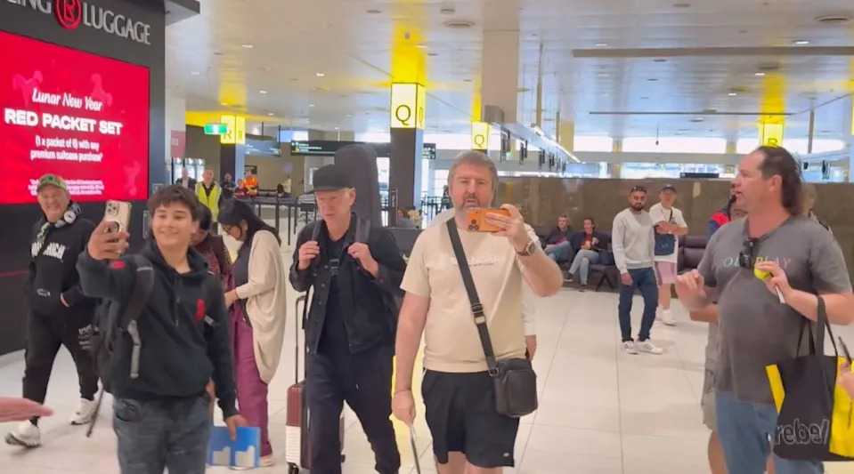 A fan takes a selfie with John McEnroe at the Melbourne Airport. Media-Mode / SplashNews.com