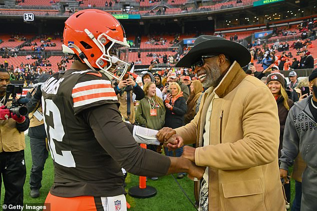 Quarterback Shedeur Sanders of the Browns greets his father, NFL great Deion Sanders