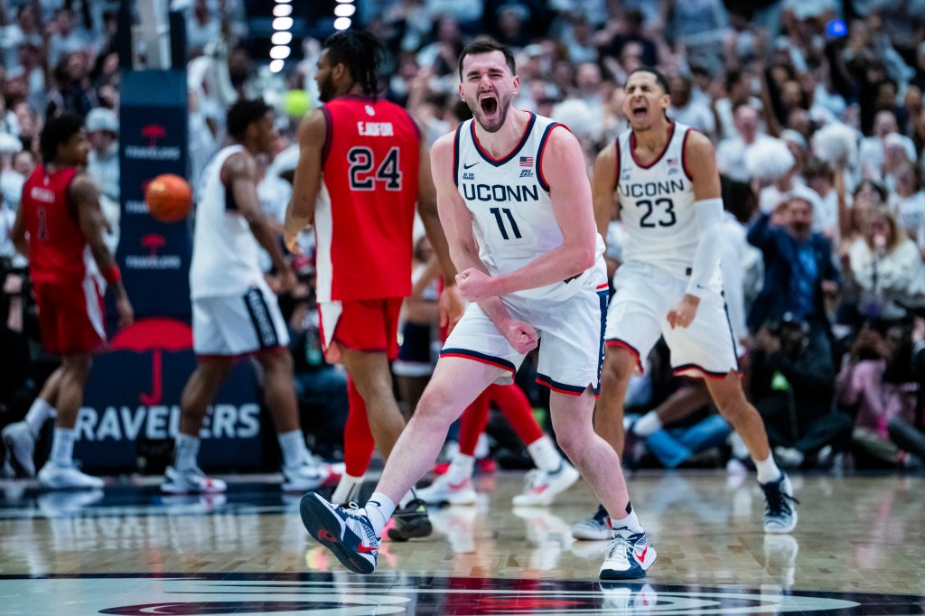 UConn basketball players Alex Karaban and Jayden Ross react during a game.