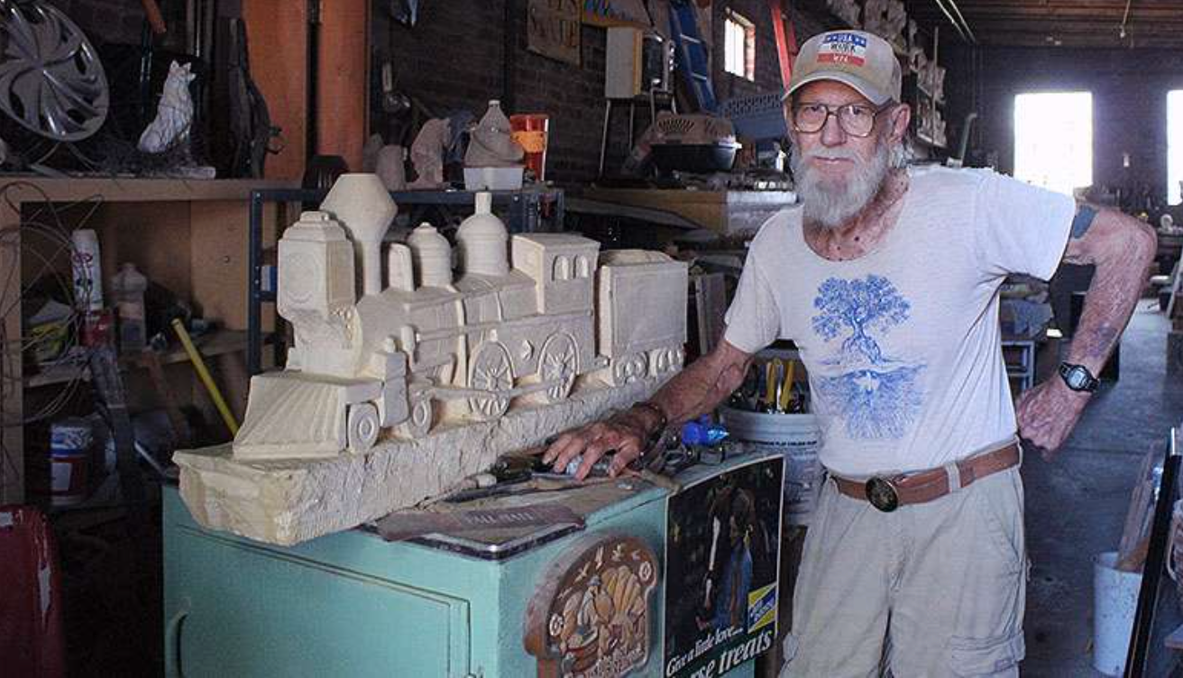 Pete Felten pictured with a train statue in 2020 prior to its installation at the Union Pacific Park in Hays. Hays Post file photo