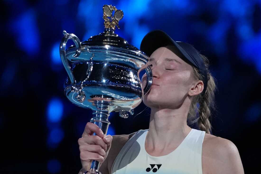 Elena Rybakina of Kazakhstan kisses the Daphne Akhurst Memorial Cup after defeating Aryna Sabalenka of Belarus to win the women's singles final at the Australian Open tennis championship in Melbourne, Australia on Saturday.