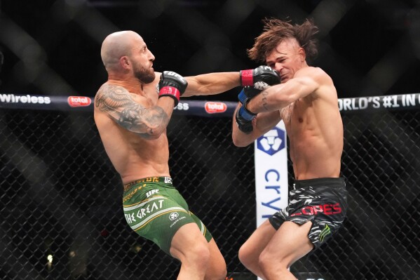 Alexander Volkanovski, left, and Diego Lopes, right, battle during a mixed martial arts fight at UFC 314, April 13, 2025, in Miami. (AP Photo/Lynne Sladky, File)