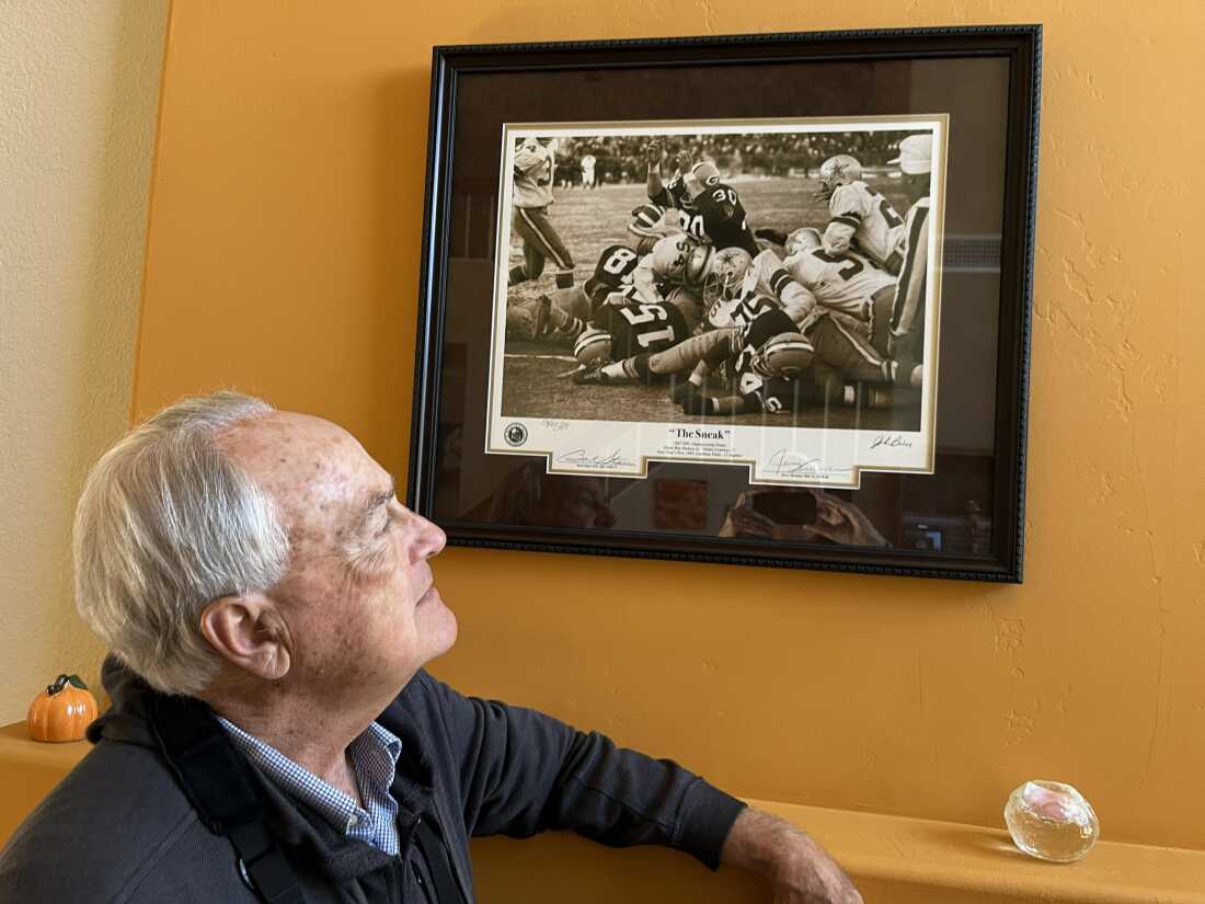 John Biever looks at his most iconic photo taken in the 1967 Ice Bowl between the Green Bay Packers and Dallas Cowboys as it hangs in the living room of his San Diego home.