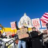 Students hold signs withe messages such as "ICE out!" in front of the Capitol building in St. Paul, Minnesota.