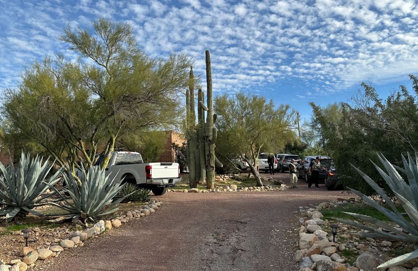 Law enforcement officers are seen outside Nancy Guthrie's home near Tucson on Monday.