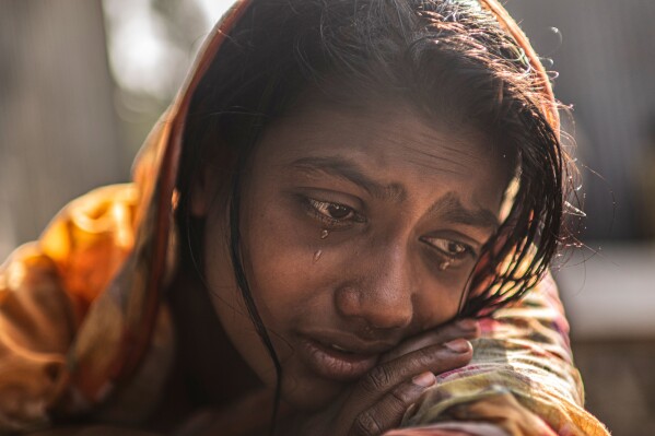 Meghna Rani, wife of Dipu Chandra Das who was beaten to death by a mob, his body hung from a tree and set on fire, for alleging making derogatory remarks about the Prophet Muhammad, weeps inside her home in Tarakanda, Bangladesh, Jan. 9, 2026. (AP Photo/Mahmud Hossain Opu, File)