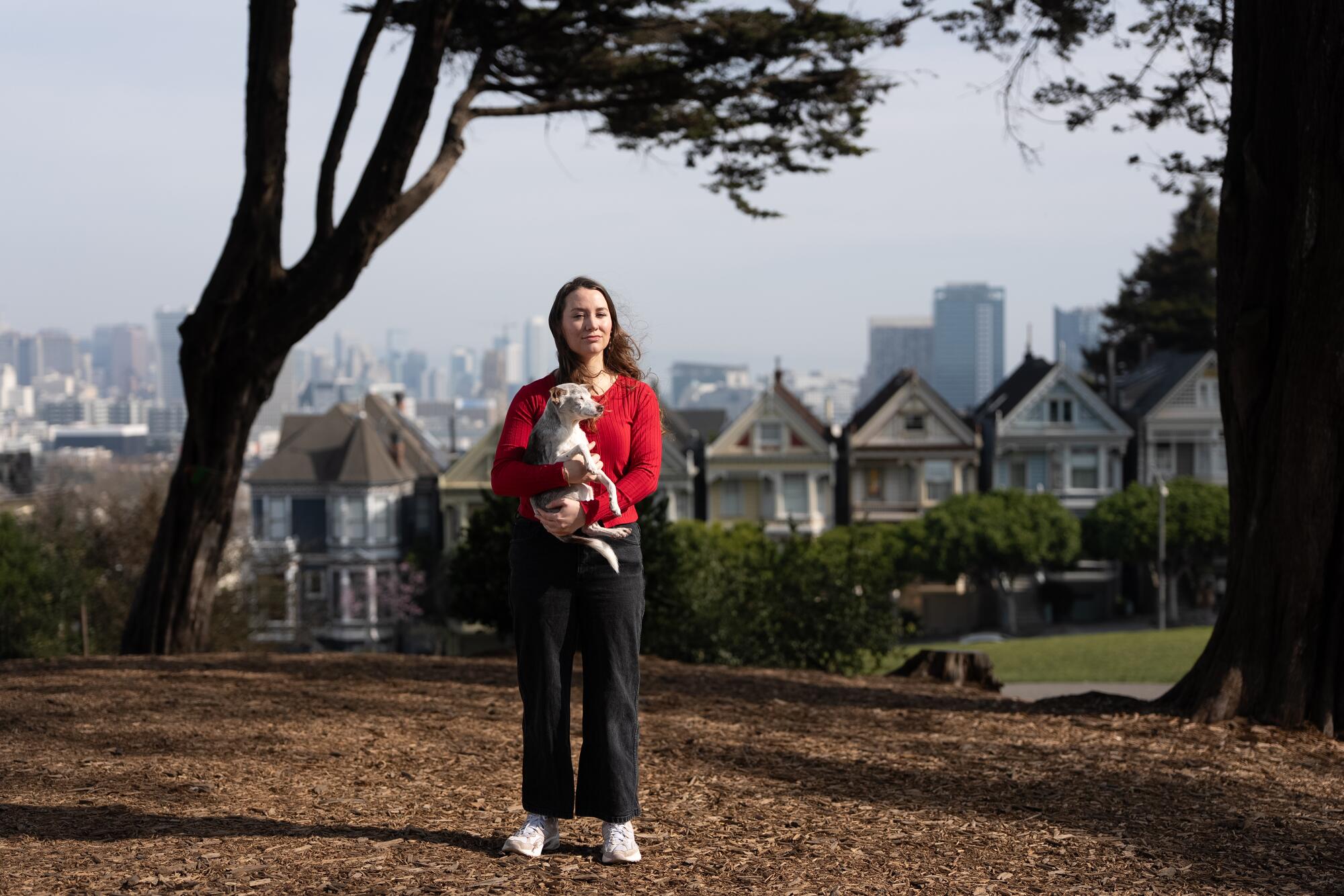 Mikayla Tencer, a marketing influencer, with her elder dog, "Lucky" at Alamo Square Park.