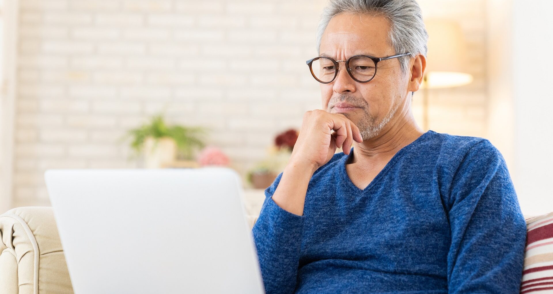 Elderly man using laptop, think, stock photo