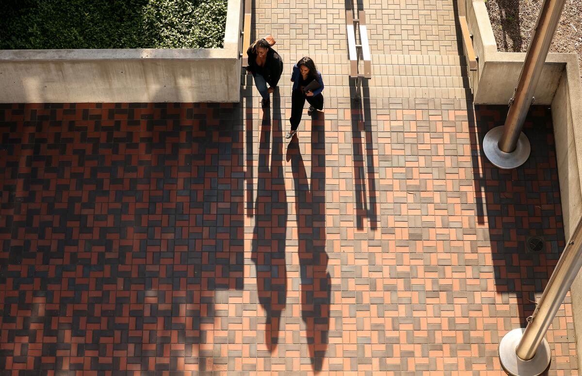Nithya Raman, right, arrives with her chief of staff Andrea Conant to file paperwork to run for mayor