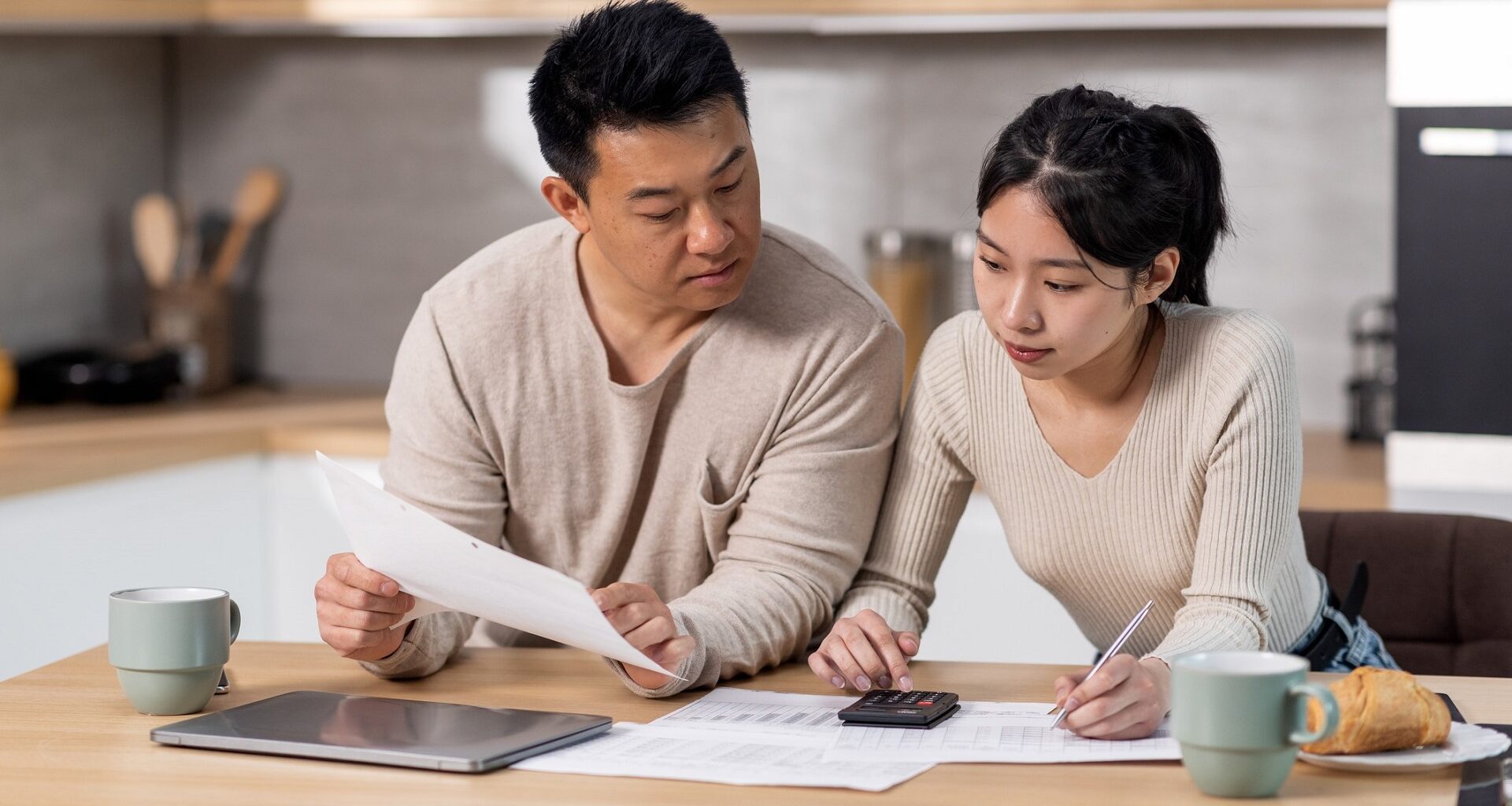 Family counting monthly expenses, kitchen interior stock photo