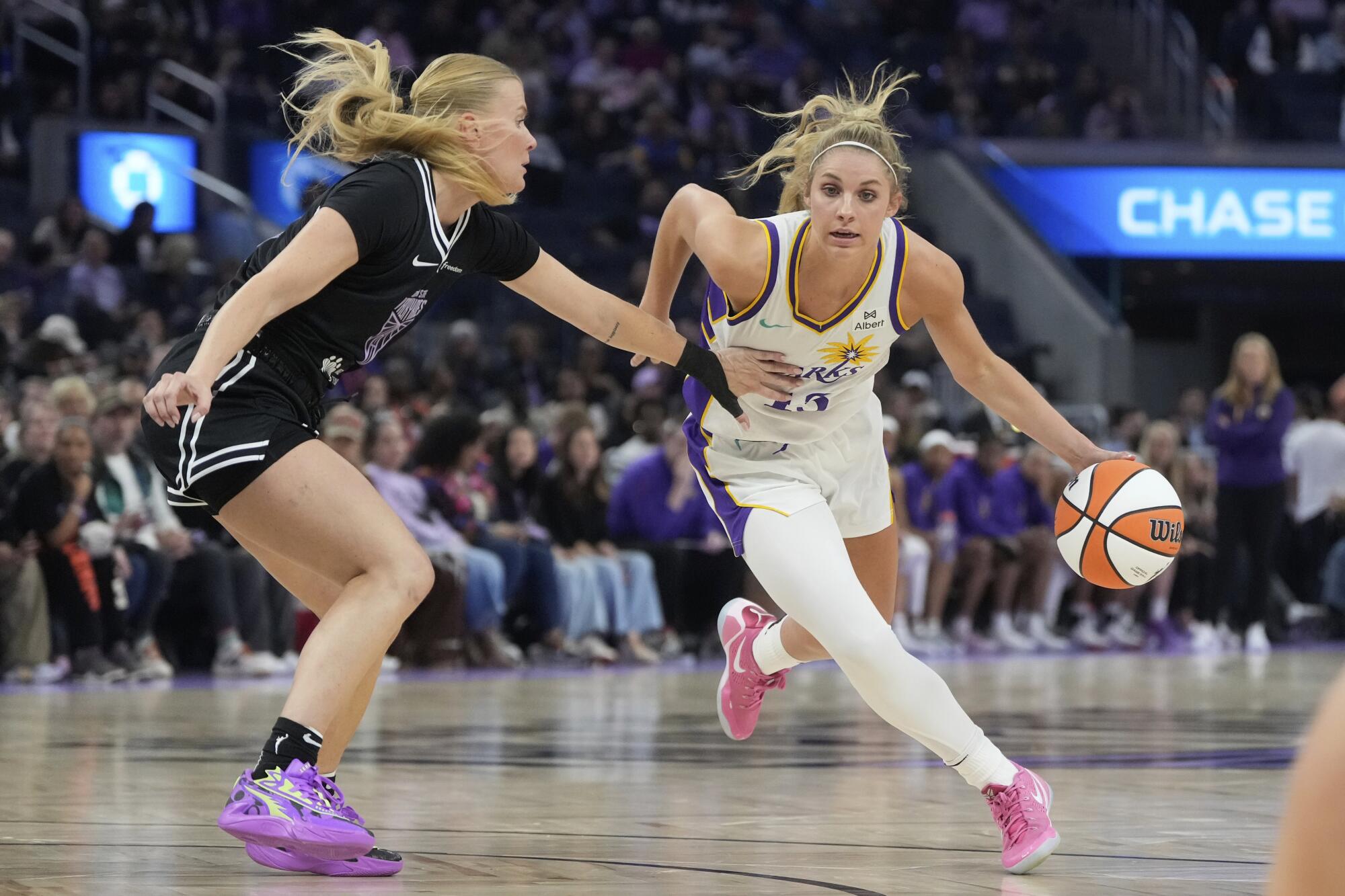 Sparks guard Sarah Ashlee Barker, right, drives to the basket against Golden State Valkyries guard Julie Vanloo.