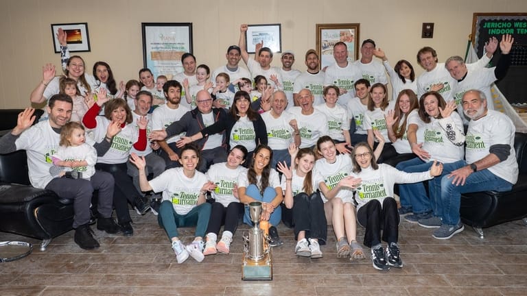 A group photo of the family, who played the doubles...