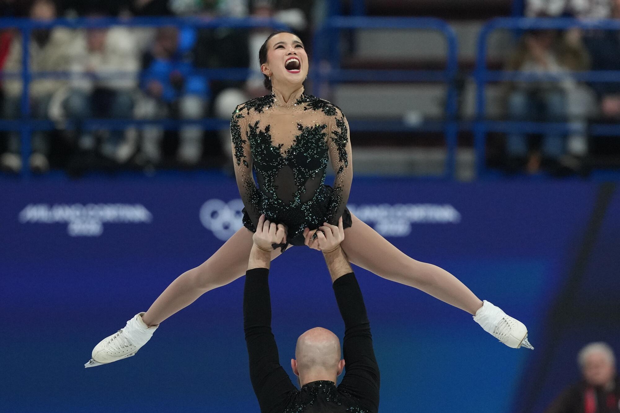 Ellie Kam and Danny O'Shea perform in pairs figure skating during the team competition at the Milan-Cortina Games.