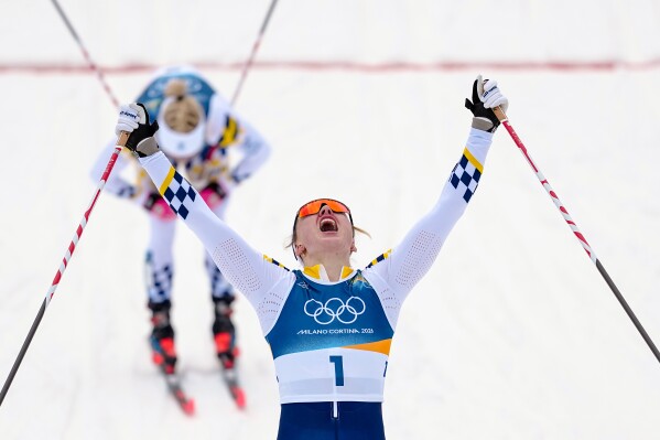 Linn Svahn, of Sweden, crosses the finish line ahead of Jonna Sundling, also of Sweden, to win the gold medal in cross-country skiing women's sprint classic at the 2026 Winter Olympics, in Tesero, Italy, Tuesday, Feb. 10, 2026. (AP Photo/Matthias Schrader)