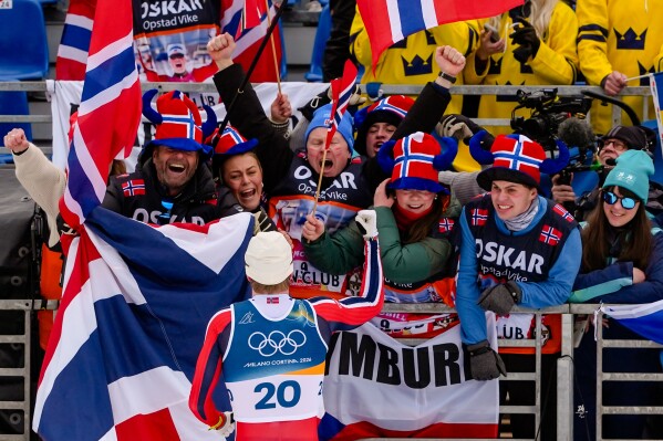 Oskar Opstad Vike, of Norway, celebrates with fans after winning the bronze medal in the cross-country skiing men's sprint classic at the 2026 Winter Olympics, in Tesero, Italy, Tuesday, Feb. 10, 2026. (AP Photo/Kirsty Wigglesworth)