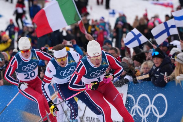 Johannes Hoesflot Klaebo, of Norway, from right, Ben Ogden, of the United States, and Oskar Opstad Vike, of Norway, compete in the final of the cross-country skiing men's sprint classic at the 2026 Winter Olympics, in Tesero, Italy, Tuesday, Feb. 10, 2026. (AP Photo/Kirsty Wigglesworth)