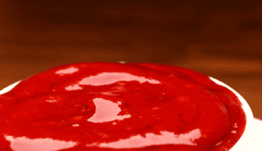 Person dipping fry in ketchup