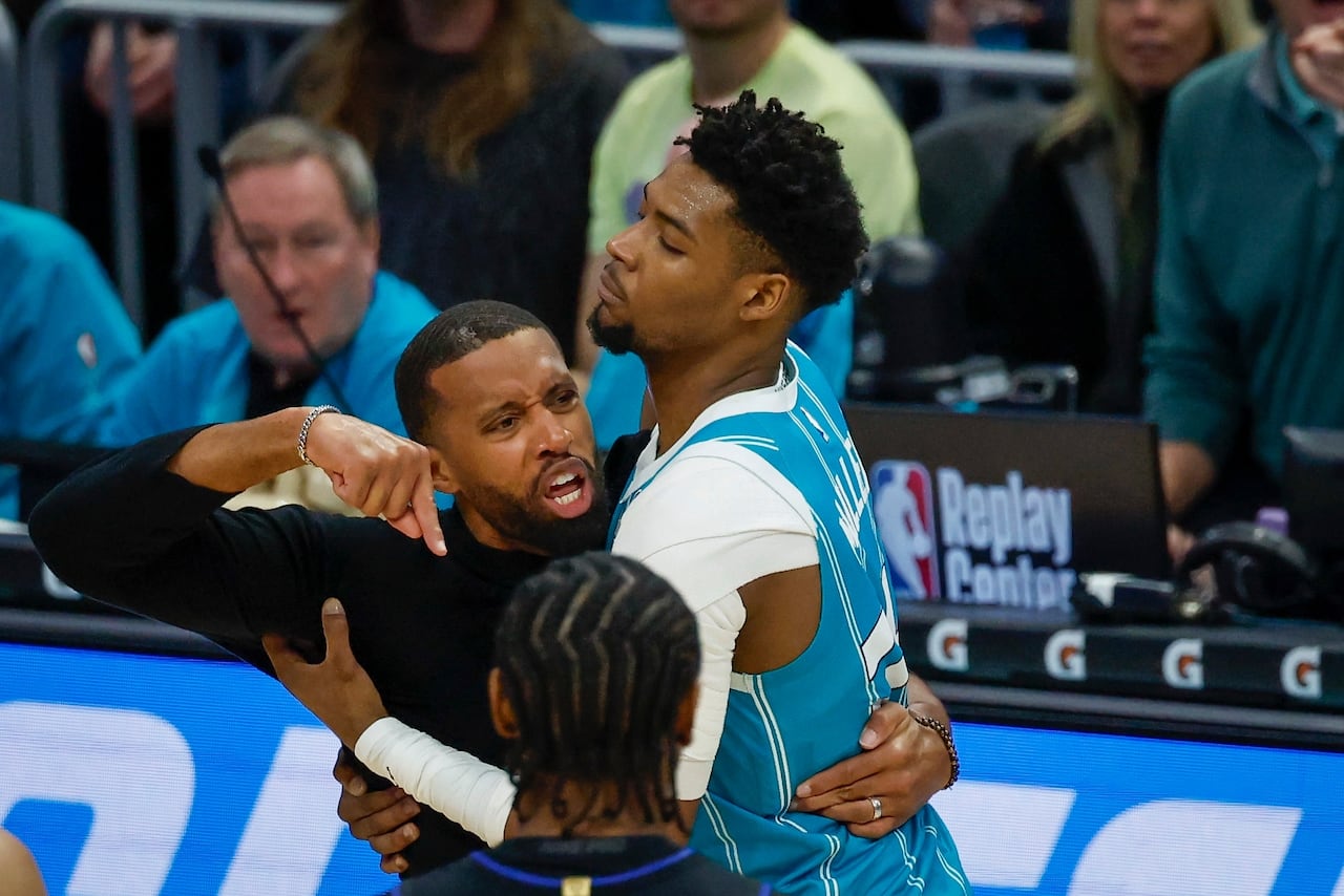 Charlotte Hornets forward Brandon Miller, right, holds back Hornets head coach Charles Lee, left, who yells at an official during the second half of an NBA basketball game against the Detroit Pistons in Charlotte, N.C., Monday, Feb. 9, 2026. 