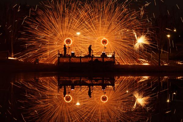 Chinese folk performance known as da shuhua, or molten iron fireworks ahead of Lunar New Year celebrations in Beijing, Feb. 9, 2026. (AP Photo/Vincent Thian, File)
