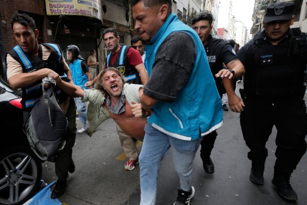 Police detain a protester during a march by trade unions and opposition groups protesting a labor reform bill proposed by President Javier Milei's government, in Buenos Aires, Argentina, Feb. 11, 2026. (AP Photo/Gustavo Garello, File)