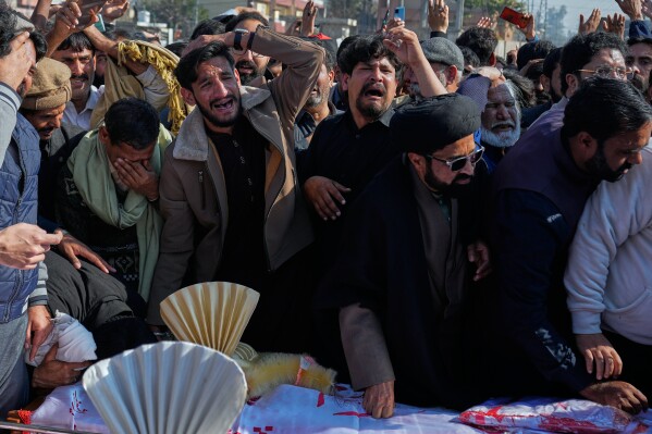 People react next the coffin of their relatives, who were killed in a suicide bombing inside a Shiite mosque, in Islamabad, Pakistan, Saturday, Feb. 7, 2026. (AP Photo/Anjum Naveed, File)