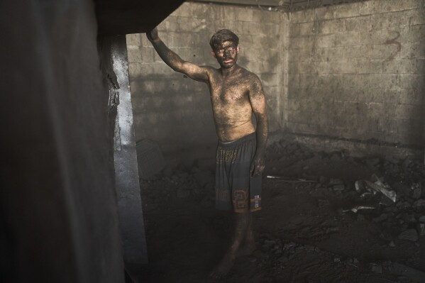 Diego Armando Custodio stands inside the coal sales market where he works in Buenos Aires, Argentina, Feb. 10, 2026. (AP Photo/Rodrigo Abd, File)