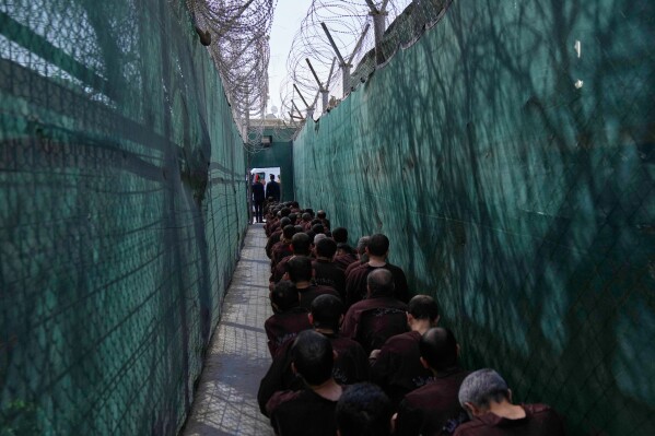 Iraqi security forces lead suspected Islamic State militants for questioning, after they were transferred from Syria, at Al-Karkh Central Prison in Baghdad, Iraq, Feb. 12, 2026. (AP Photo/Hadi Mizban, File)