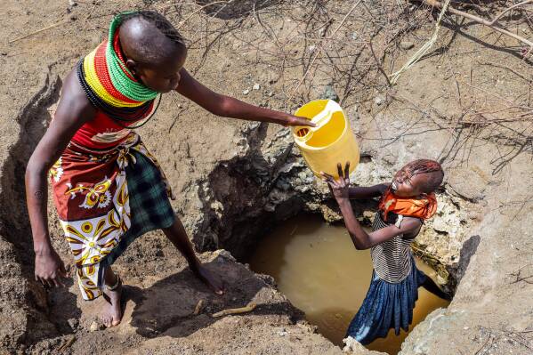 Turkana women fetch water from a well in Lopii village, Turkana County, Kenya, Feb. 9, 2026. (AP Photo/Patrick Ngugi, File)