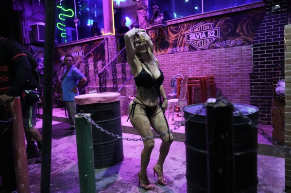 A sex worker dances during a pre-Carnival street party in the Vila Mimosa red-light district in Rio de Janeiro, Feb. 6, 2026. (AP Photo/Silvia Izquierdo, File)