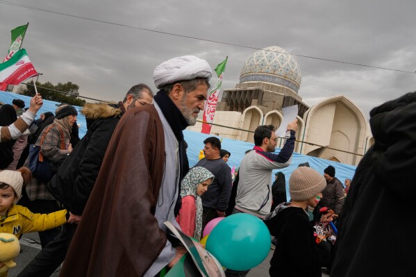 A cleric and other people attend an annual rally marking the 1979 Islamic Revolution in Tehran, Iran, Feb. 11, 2026. (AP Photo/Vahid Salemi, File)